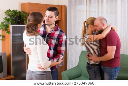 Two couples dancing  slow dance at living room