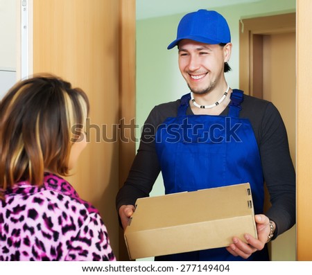 Smiling postman delivered a parcel to girl at home