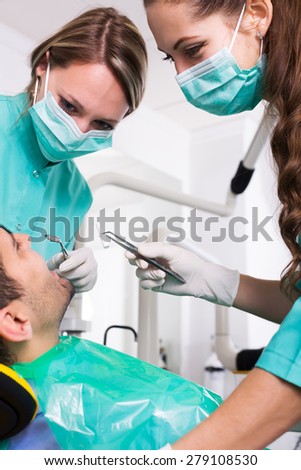 Terrified adult client and dental clinic crew during check up