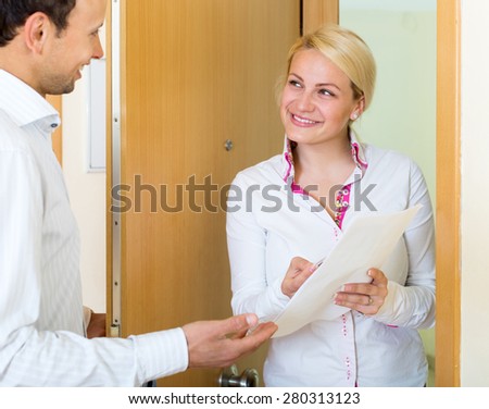 Cheerful woman conducting  survey among people at door