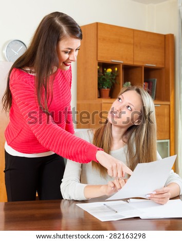 business women discussing the paper at the table