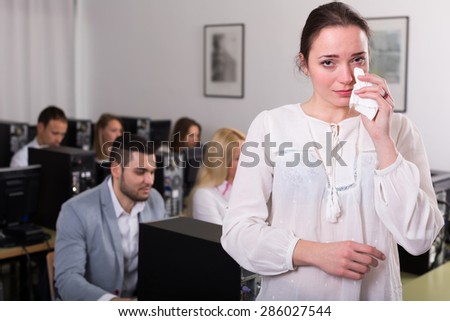 Crying office worker at open space working area