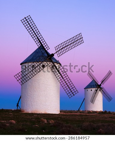 Two windmills at field in sunrise. La Mancha, Spain