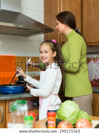 Portrait of smiling girl and mom prepare vegetables in casserole