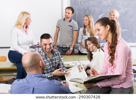adult students chatting at training session for employees during break in classroom