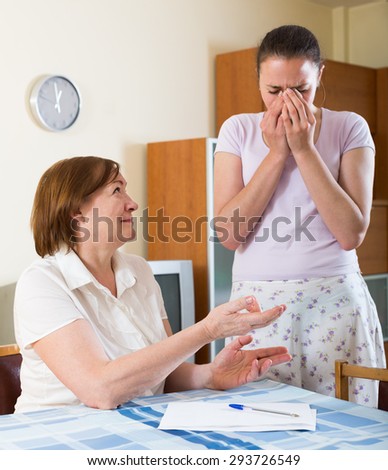 sad women with  documents at table in  office interior