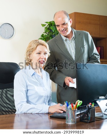 elderly businessman and secretary working in the office