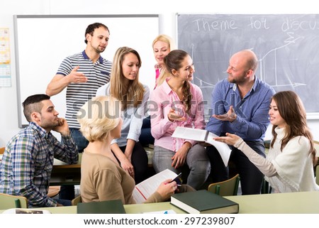 Teacher having informal discussion with his graduate students during a break between subjects
