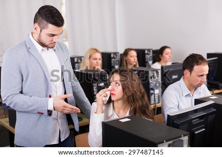 Furious manager scolding unhappy office worker