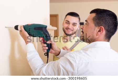 Two skilled men doing maintenance work at home