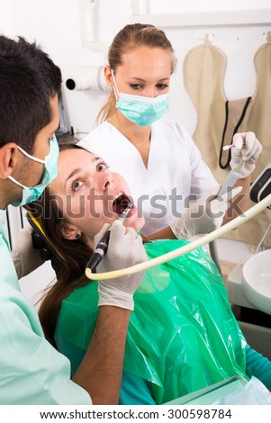 female adult patient  treats teeth in the dental clinic. Focus on the patient