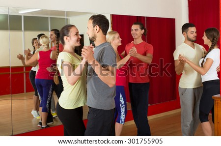 Group of spanish  people dancing rumba in studio