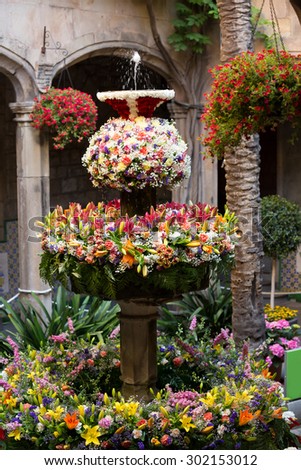Feast of Corpus Christi. Eggs on jet of water in the fountains decorated with flowers at gothic district