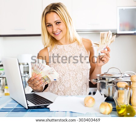 Portrait of young happy girl with money and documents indoor