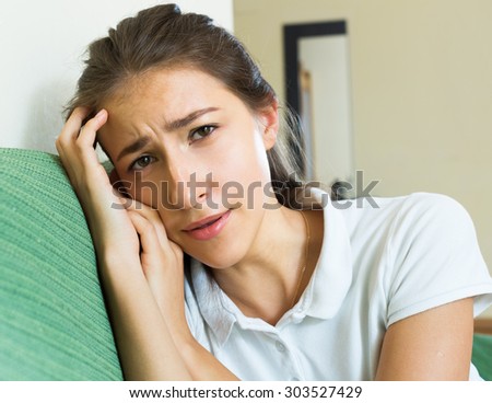Portrait of sad young girl suffering from troubles in home