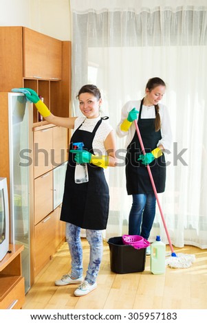 Smiling young women workers cleaning company ready to start work
