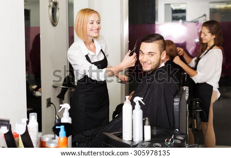 Hairdresser makes the cut for young man in the hairdressing salon