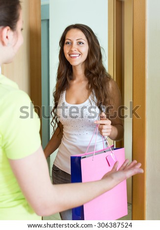 Young woman congratulating her friend and gives a gift