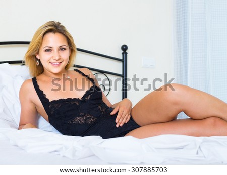 happy naked russian woman on bed in bedroom