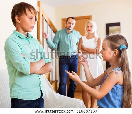 Girl talking with his brother in  presence of parents