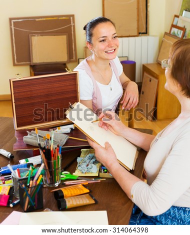 Artist paints a portrait of a woman with a pencil