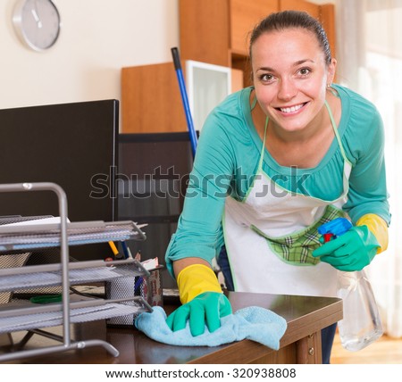 smiling professional spanish cleaner  cleaning the office
