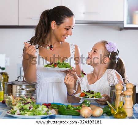 happy russian family of two having healthy lunch with veggies at home