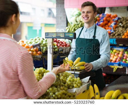 free photos friendly seller weighing healthy bananas on scale for