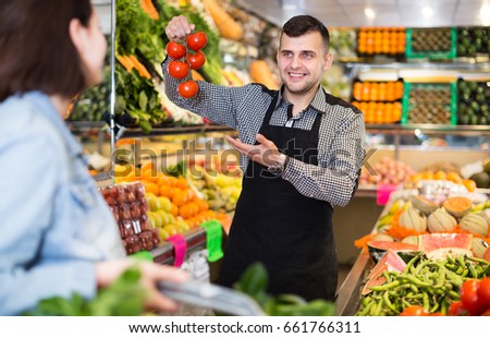 royalty free friendly seller weighing eco bananas on 523323760