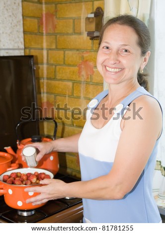 Similar – Image, Stock Photo Housewife making strawberry jam. Woman cutting fruits