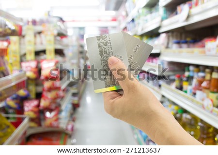 Woman hand holding credit card at convenience store
