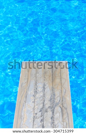 Swimming pool with old wooden diving board