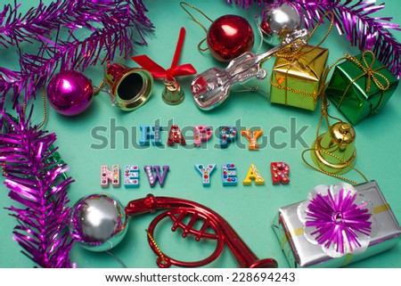 Blue and silver Happy New Year ornaments on bright holiday background