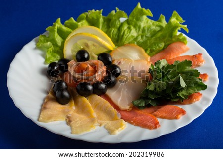 plate with assorted cutting fish isolated on blue