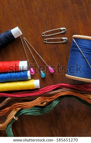 Sewing items with a vintage feel, thread, antique scissors, pins and buttons