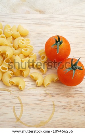 pasta product with tomato, and coffee stain on wooden table