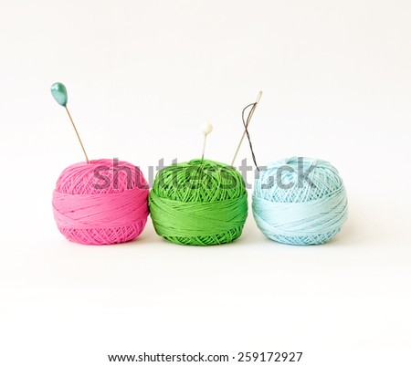 Few pins in wool ball isolated on white