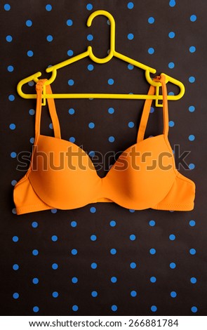 Summer concept, bra on coat hanger on blue. (Pop art style)