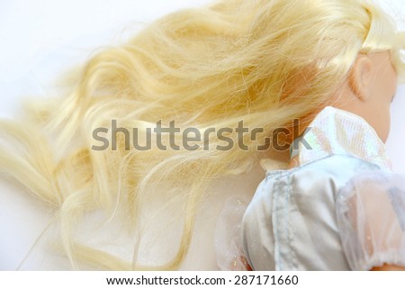 Old doll with blond hair