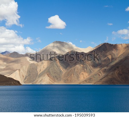 Pangong Tso mountain lake panorama with mountains and blue sky reflections in the lake (Ladakh, India)