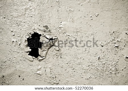 old  painted ruined surface with a black hole