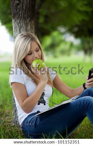 Beautiful college student relaxing in park
