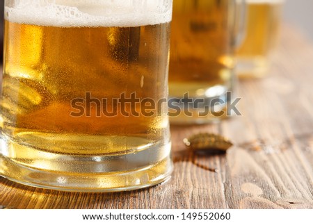 three cold beer glasses on bar or pub desk