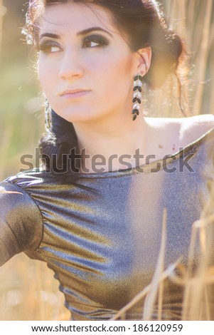 Young pretty brunette woman posing outdoor in summer meadow  Sensual girl posing in park