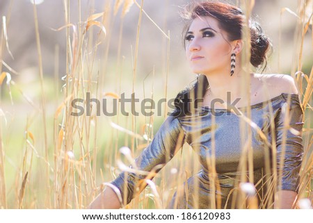 Young pretty brunette woman posing outdoor in summer meadow  Sensual girl posing in park