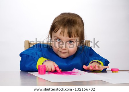 Little girl painting finger paint on paper