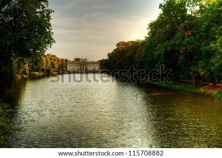 ?azienki Park with Palace on the Water, a lake and trees in the picture.