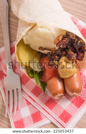 sausages and mash in a cone of flat cake (tortilla)
