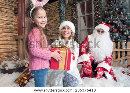 happy girl received a gift from Santa Claus and Snow Maiden