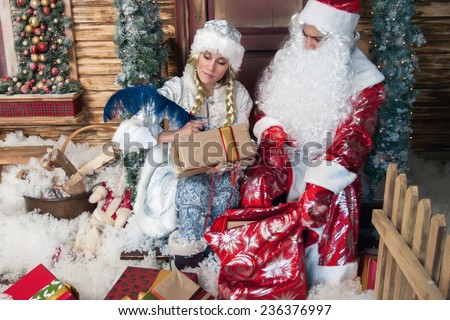 beautiful snow maiden wrote wishes for the new year under the dictation of Santa Claus